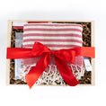 Load image into Gallery viewer, A folded red and white patterned turkish linen presented in a light wood gift box with shredded paper filler and tied with a wide red ribbon. A small tag is visible on the right side.