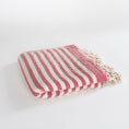 Load image into Gallery viewer, A folded Turkish cotton towel with red and off-white stripes and cream fringe tassels, displayed on a clean white background.
