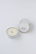 Load image into Gallery viewer, A white wax candle in a round white tin with a thin gold rim, shown next to one closed matching tin on a clean white background. One open tin label reads 'Be My Bridesmaid' and the brand 'effing candle co' is visible at the top.