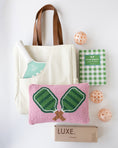 Load image into Gallery viewer, A coordinated pickleball gift set on a white background, including a cream canvas tote bag with brown handles, a green and white checkered pickleball book, a mint-and-white striped pickleball paddle, a pink woven pickleball pillow with green net embroidery, three peach-orange pickleballs, and a brown box labeled LUXE.