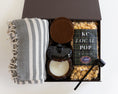 Load image into Gallery viewer, A curated gift box set on a white background, featuring a gray and white patterned fringed throw blanket, a brown ceramic pumpkin candle, a brown leather coaster set, a bag of KC Local Mix Popcorn, and a black candle snuffer.
