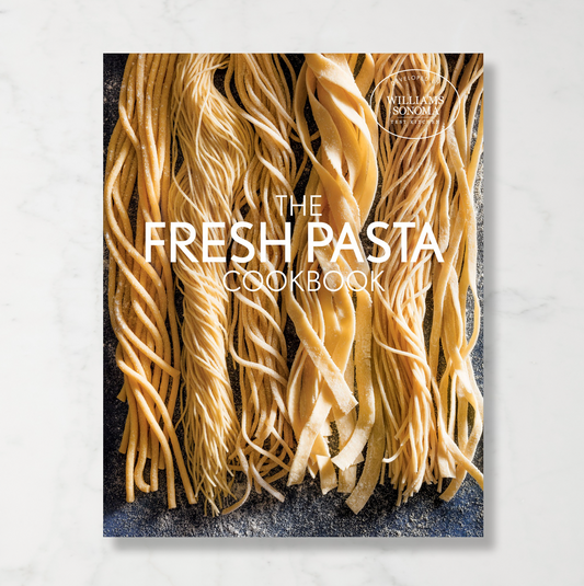 Williams Sonoma cookbook called The Fresh Pasta Cookbook with an image of different handmade long noodles dusted in flour on the front cover.