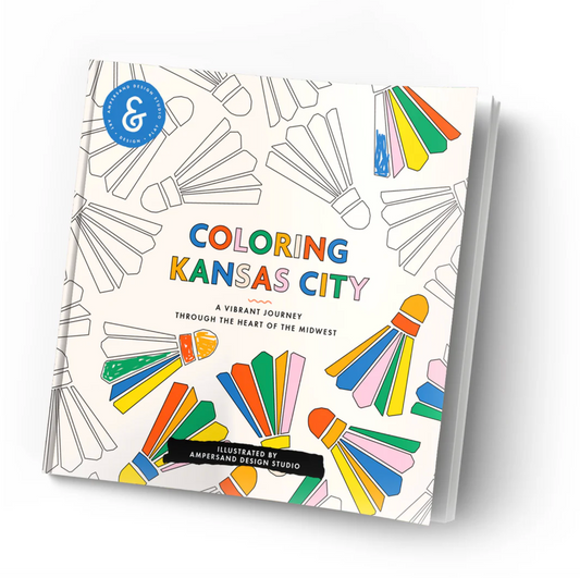 A coloring book titled 'Coloring Kansas City' shown at an angle on a white background. The cover features black outline illustrations of shuttlecocks with several shuttlecocks filled with bright colors like blue, green, yellow, orange, pink, and purple.