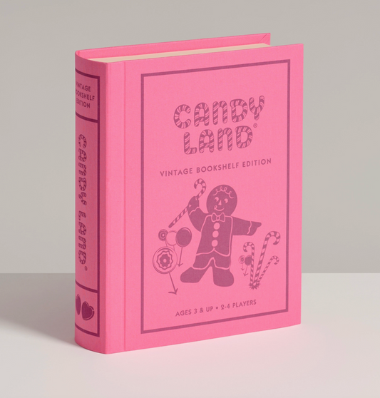 The pink cover of the Candy Land board game box, which looks like a large vintage book. 