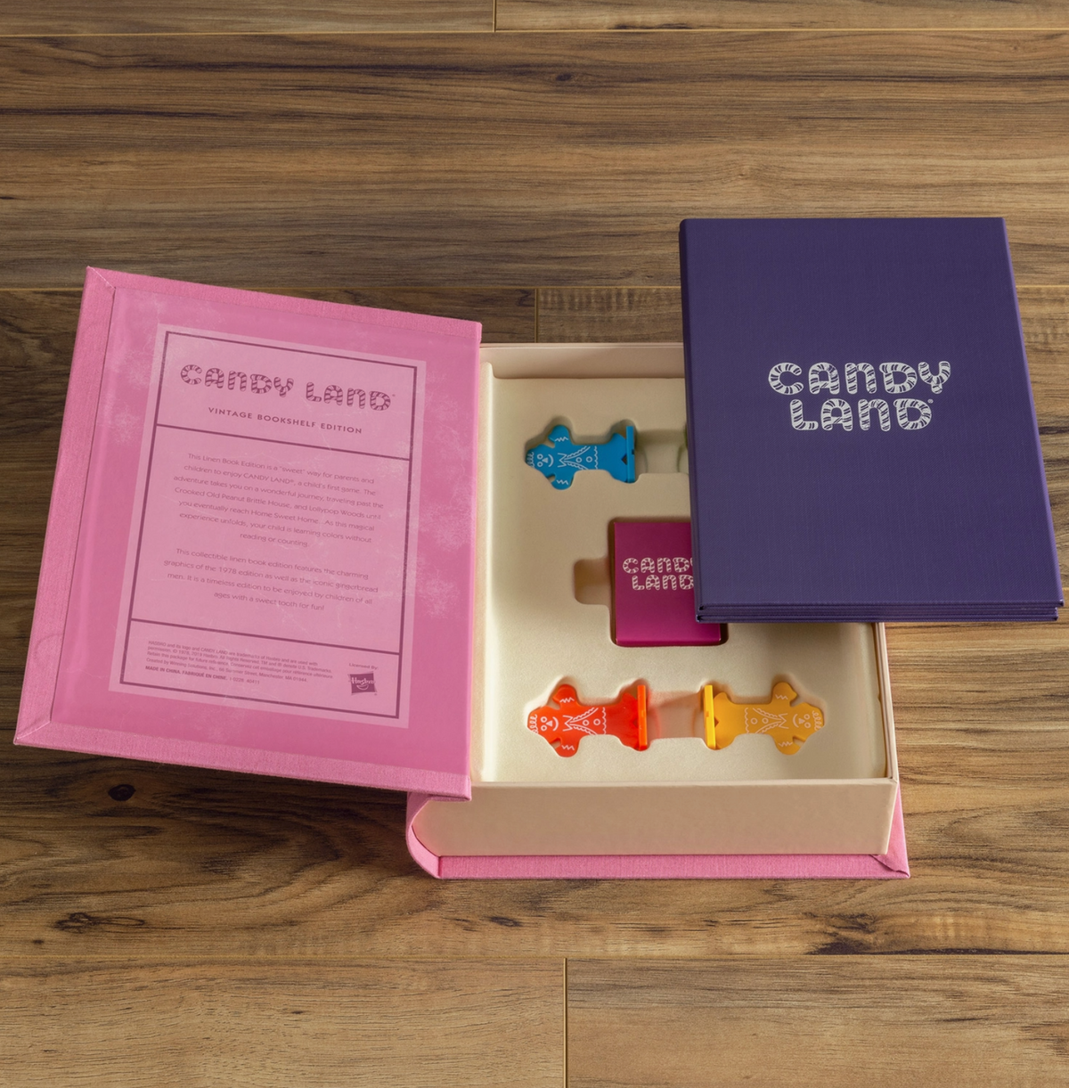 An open look at the Candy Land board game box with game pieces shown. 