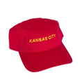 Load image into Gallery viewer, A red baseball cap with 'KANSAS CITY' embroidered in yellow on the front, shown against a plain white background.

