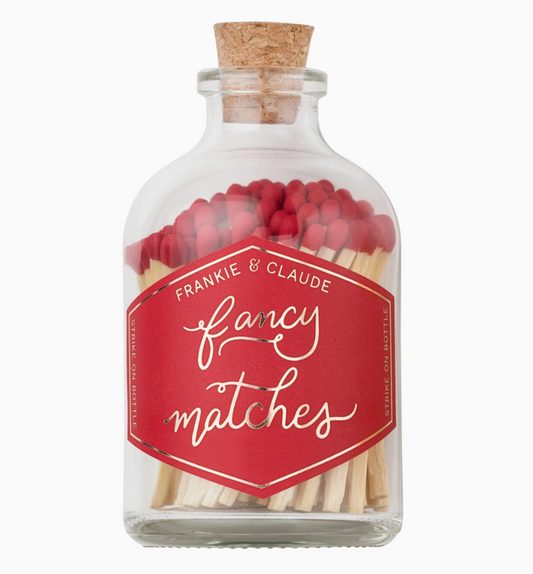 A clear jar of fancy matches with red-tipped matches and a red label that reads "Fancy Matches"