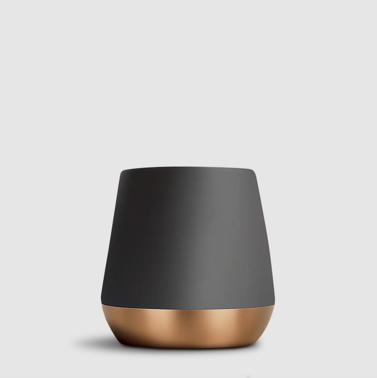 A modern tapered mug with a matte dark gray upper body and a metallic rose gold base, shown on a light gray background.