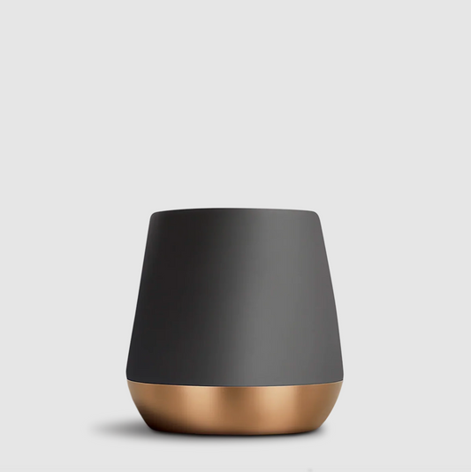 A modern tapered mug with a matte dark gray upper body and a metallic rose gold base, shown on a light gray background.