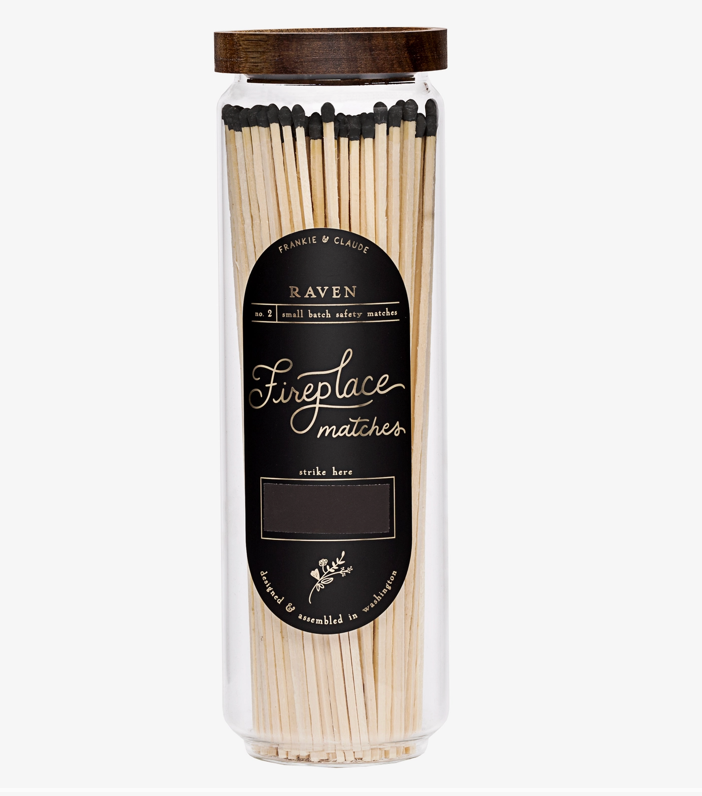 A clear cylindrical jar of Raven Fireplace Matches with a dark brown wooden lid and a black label, shown on a light gray background.