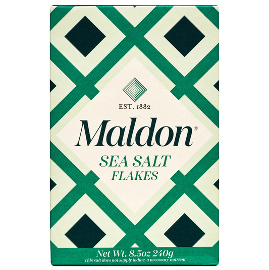 A rectangular box of Maldon Sea Salt Flakes with a green and cream geometric diamond pattern, featuring the brand name 'Maldon' and 'EST. 1882' on the front.