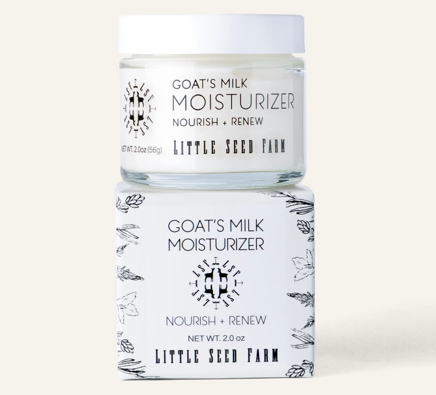 A jar of Goat's Milk Moisturizer by Little Seed Farm sits on top of its matching white box. The packaging features black text and delicate botanical line drawings on a white background, set against a solid light beige backdrop.