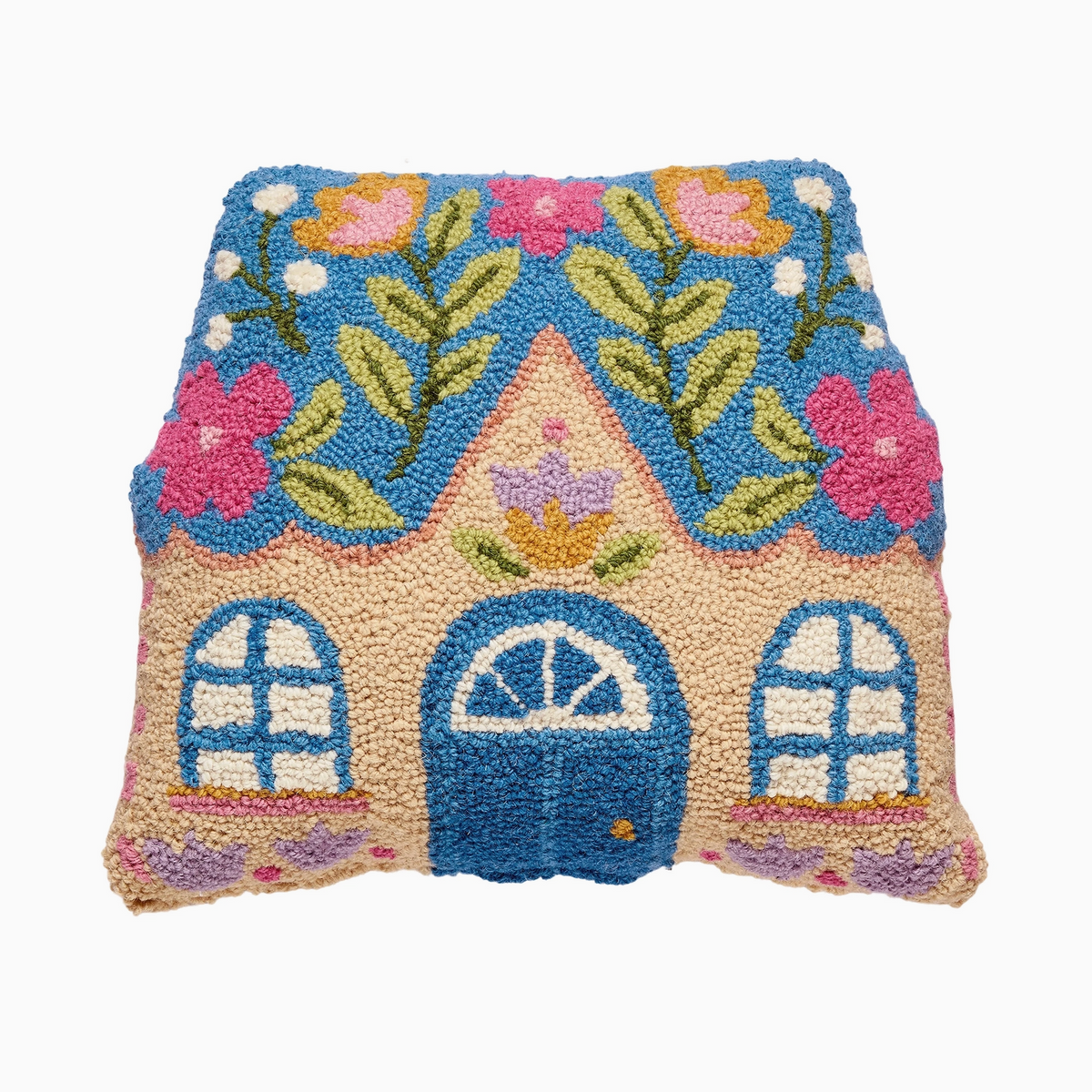 A colorful hand-tufted house-shaped pillow on a plain white background. The design features a blue roof with pink and yellow flowers, green leaves, and a beige house body with a blue door and blue windows.