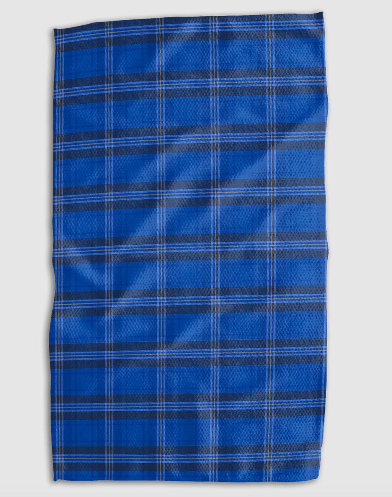 A rectangular blue plaid towel with white and navy intersecting stripes, laid flat against a light gray background.