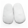 Load image into Gallery viewer, A pair of white soles with a textured, dotted grip pattern belonging to baby shoes, shown from a top-down view on a white background.
