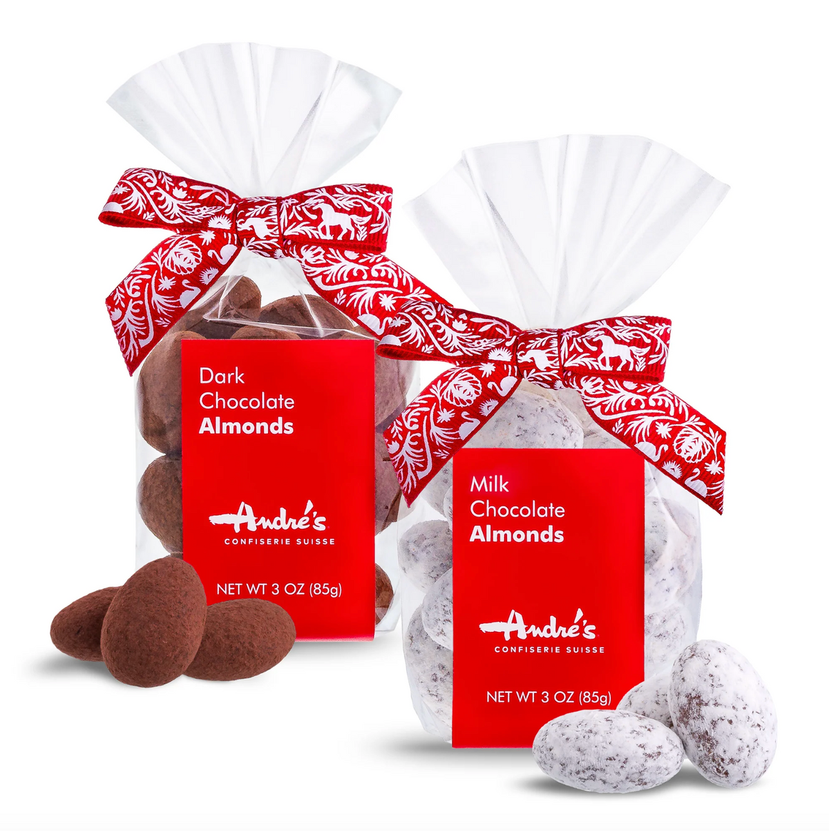 Two 3 oz bags of Andre's Confectionery chocolates, one with dark chocolate almonds and one with milk chocolate almonds, both in clear bags with red labels and white ribbon bows, shown on a white background with loose almonds in front.