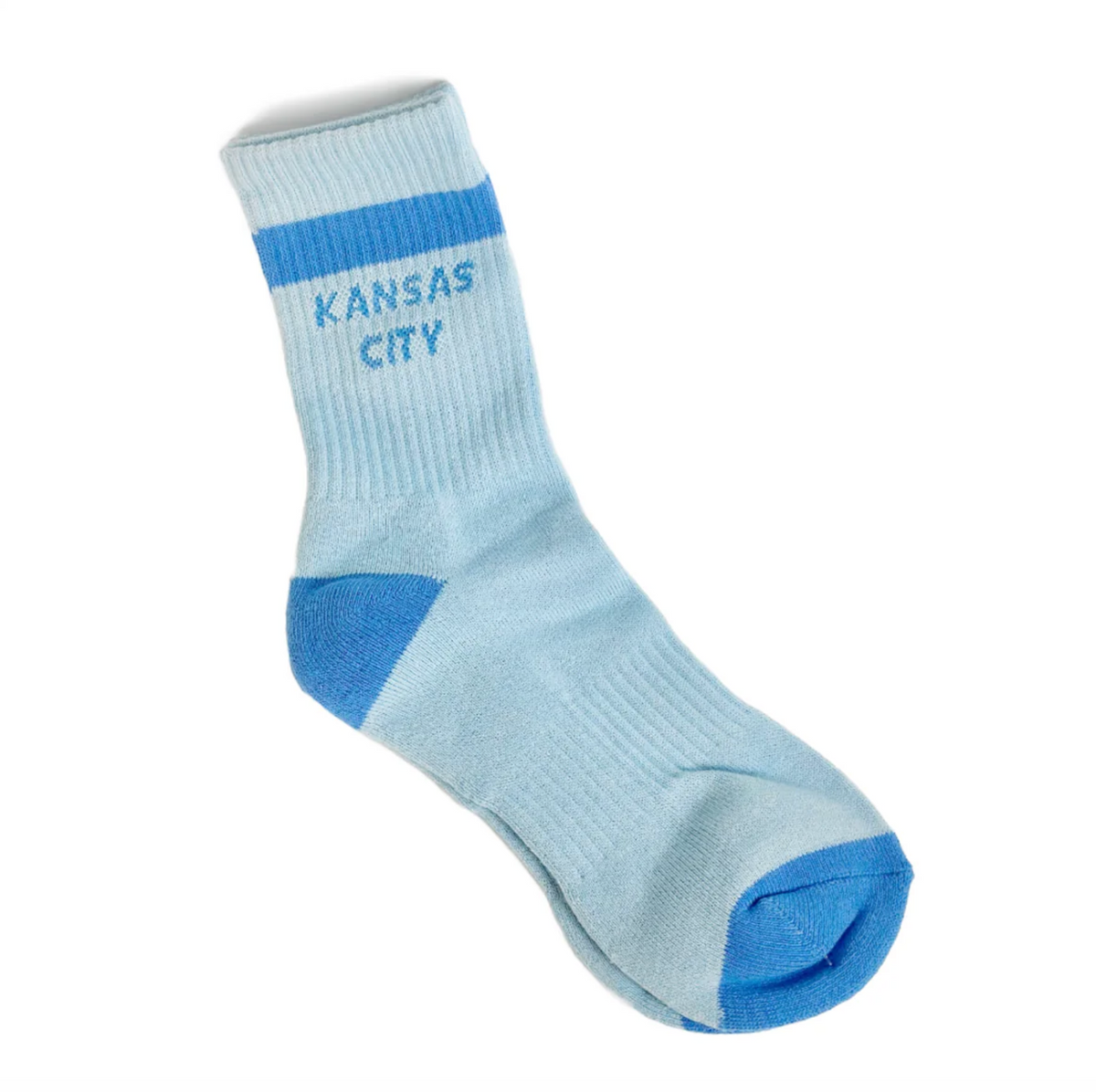 A light blue crew sock with a darker blue stripe and 'KANSAS CITY' text on the cuff, plus blue toe and heel accents, shown on a plain white background.