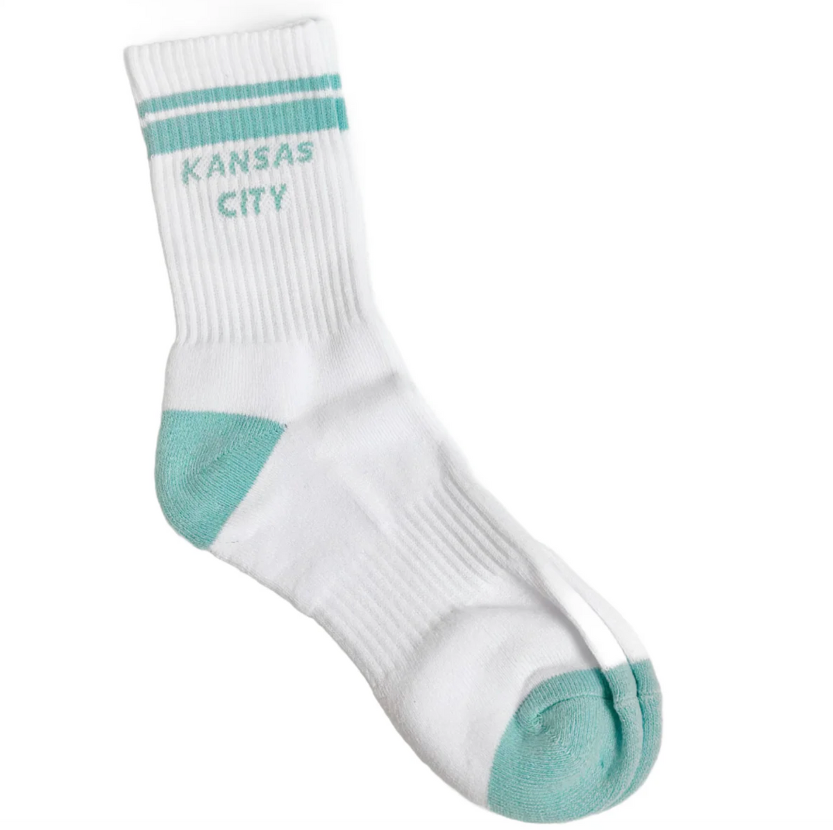 A single white crew sock with mint green accents, featuring 'KANSAS CITY' printed in mint green on the ribbed ankle area with two horizontal mint green stripes above it. The sock is photographed on a clean white background.