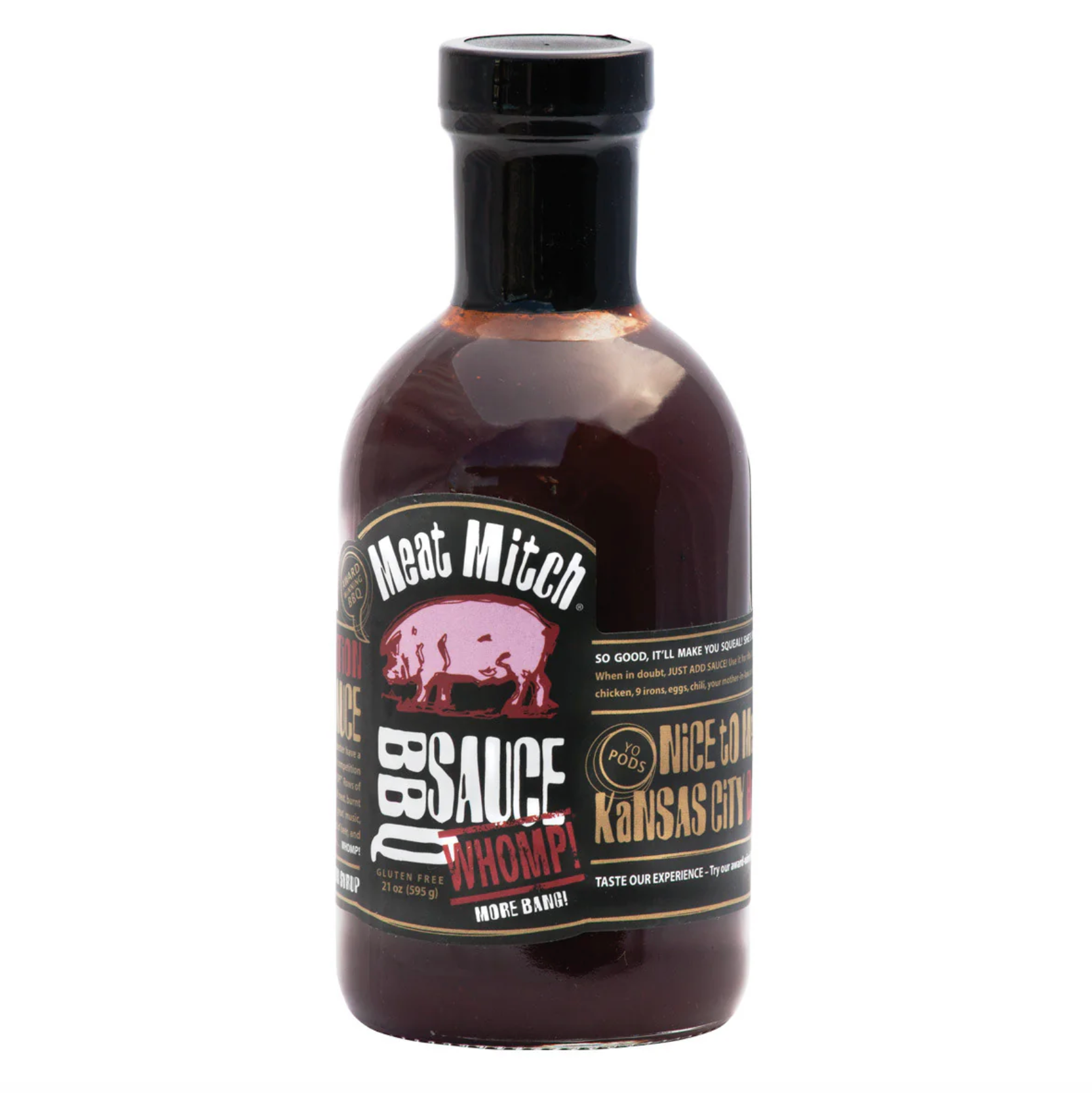 A bottle of Meat Mitch WHOMP Kansas City BBQ sauce on a plain white background. The bottle is made of dark glass showing the dark reddish-brown sauce inside, with a black cap and a black, red, and gold label.