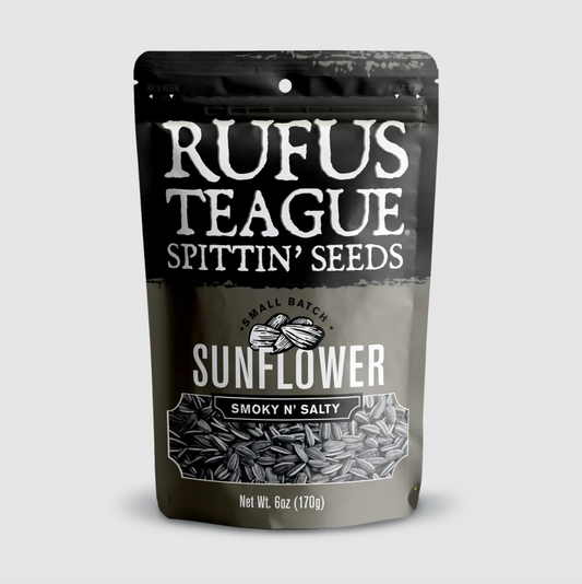 A stand-up pouch of Rufus Teague Spittin' Seeds Smokey 'N Salty Sunflower seeds, shown on a light gray background.