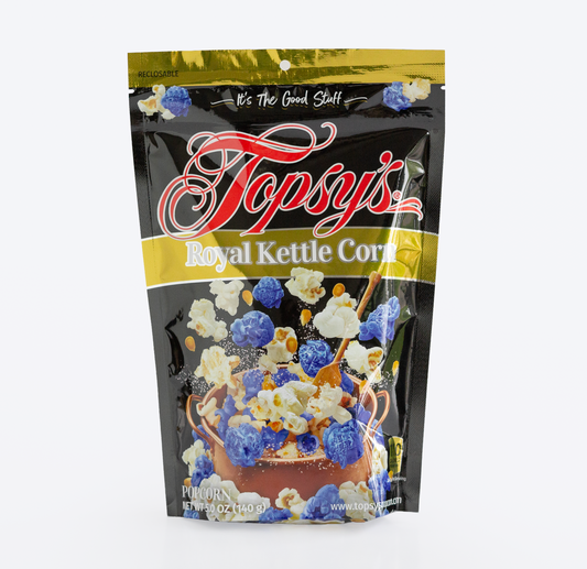 A bag of Topsy's Royal Kettle Corn on a plain white background. The packaging is primarily black with gold bands, red script branding, and a graphic showing blue and white popcorn.