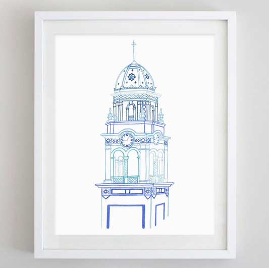 A framed art print featuring a blue architectural line drawing of a tower on a white background, enclosed in a white frame.