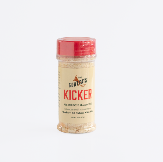 A clear plastic bottle of all purpose seasoning from Goat Eats with a red cap and red design on the label.