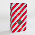 Load image into Gallery viewer, Mersea Cider by the Sea reed diffuser in its retail packaging, featuring a red and light blue diagonal striped design with gold lettering.
