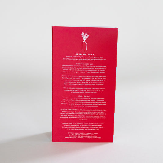 The back of a red rectangular product box for a Reed Diffuser, featuring white text and a simple line drawing of a reed diffuser bottle, photographed on a clean white background.