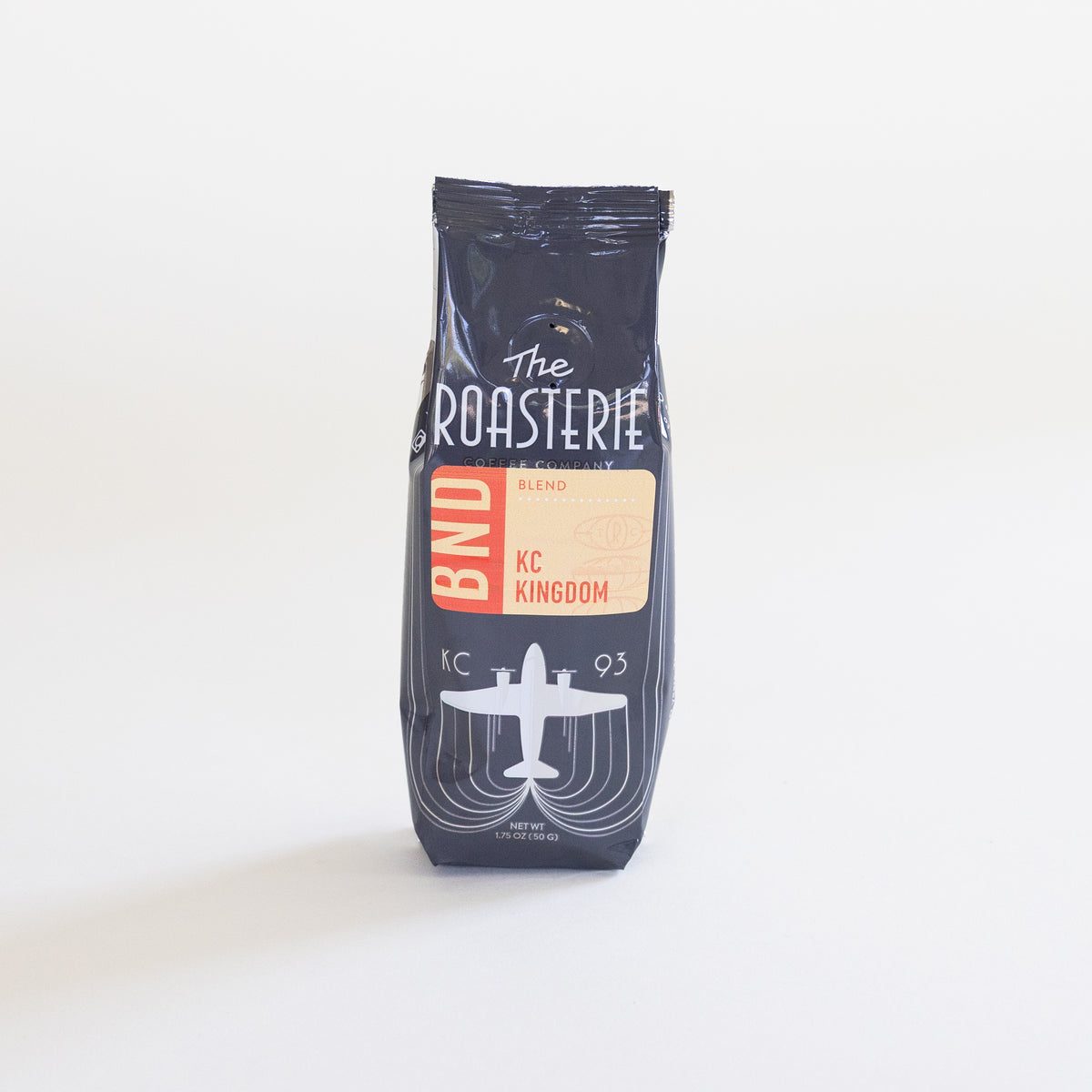 A single bag of travel size coffee from The Roasterie, specifically KC Kingdom Blend, standing upright on a clean white background.