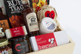Load image into Gallery viewer, A wooden gift box filled with assorted gourmet Kansas City snacks, tea, coffee, and packaged food items, photographed against a clean white background.
