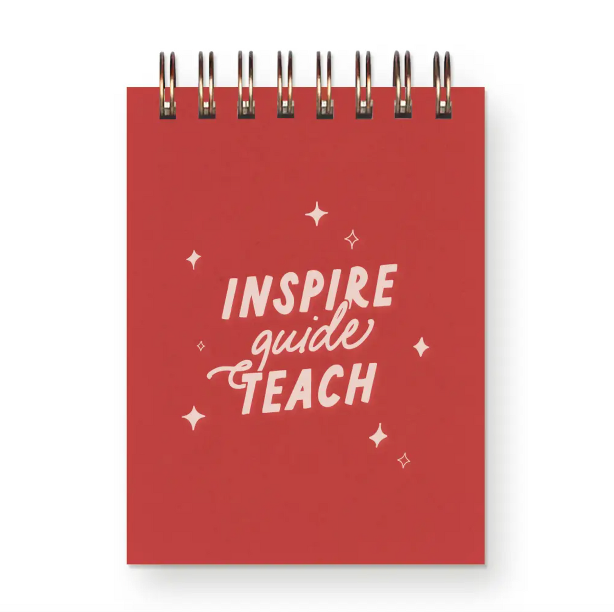 A small spiral-bound notepad in red with the words "Inspire, Guide, Teach" on the cover