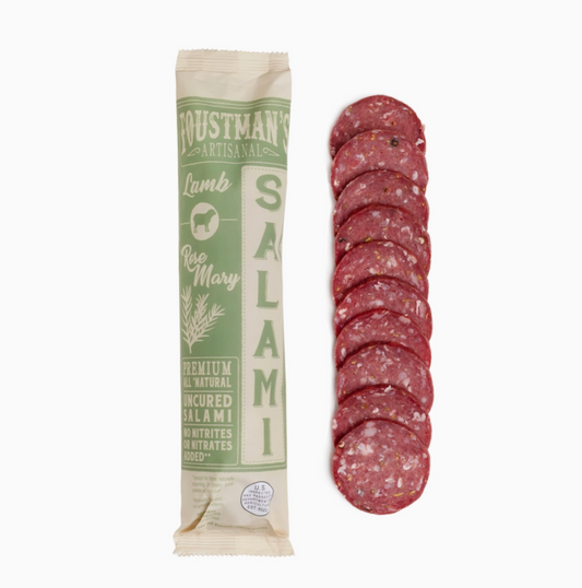 A package of Foustman's Artisanal Rosemary Lamb Salami shown next to a vertical stack of sliced salami on a plain white background.