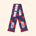 Load image into Gallery viewer, A navy blue knit scarf with red polka dots and white text reading 'WE ARE 2025 FIFA KANSAS CITY', laid flat on a light beige background.
