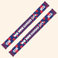 Load image into Gallery viewer, Two matching blue and red knit scarves with white text reading 'WE ARE KANSAS CITY 2026' printed repeatedly, shown on a plain light beige background.

