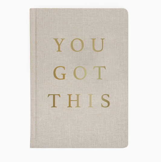 a tan fabric hardback journal with "You Got This" in gold foil letters on the front cover. 