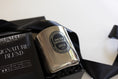 Load image into Gallery viewer, A jar candle with a reflective silver metallic finish and a black oval label reading 'SMOKE SIGNALS', presented in a black gift box with a black ribbon. Part of the black packaging box on the left reads 'SIGNATURE BLEND' and 'START COFFEE CO.
