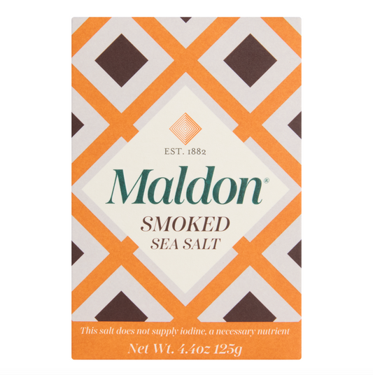 An orange and white patterned box of Maldon Smoked Sea Salt Flakes in a 4.4oz package.